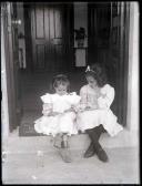 Retrato de D. Gabriela Vera de Sousa e uma menina sentadas numa soleira de uma porta (corpo inteiro)